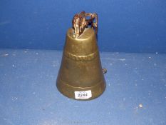 A large brass Cow Bell with chain, 8'' tall.