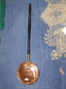 A copper/brass Warming Pan.