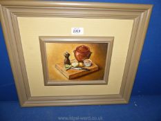 A framed J. Baxter Oil on board depicting a still life with lidded pot, pepper mill, onions etc.