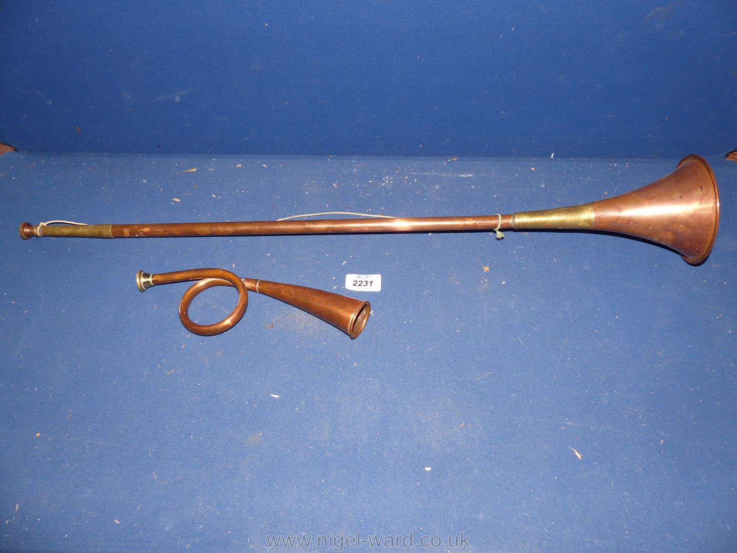 A vintage coiled copper Hunting Bugle and a copper hunting horn.