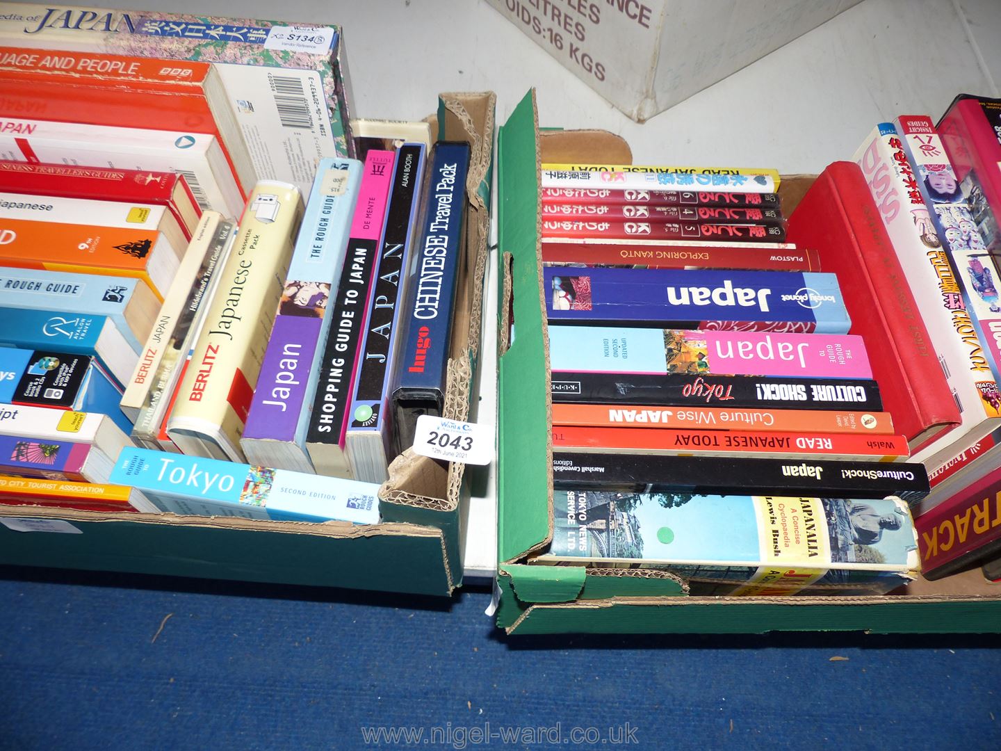 Two boxes of Japanese language and travel books and comic books.