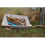 Wheelbarrow on solid tyre, saws, hand tools etc.