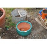 Galvanized mop bucket and a glazed pottery planter.