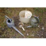 Two galvanized watering cans, mop,