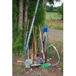 Large quantity of brooms, rakes, mops etc.