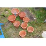 Eight various terracotta flower pots.