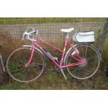 Pink Peugeot 10 speed road racing bike with pannier