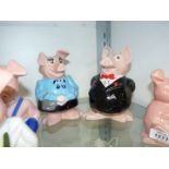 A family of Wade Nat west piggy banks.