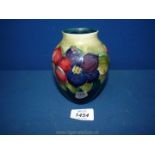 A small Moorcroft vase in Anemone pattern. 5 1/4" tall.