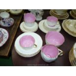 A part Teaset in cream with offset ribbed pattern with bright pink centres to include; cups,