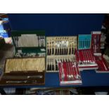 A quantity of boxed cutlery including community plate, steak knives and forks,