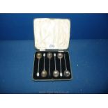 A boxed set of silver coffee bean spoons with mother of pearl ends, two ends missing,