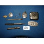 A silver propelling pencil, locket and other silver items, also an EPNS vesta case.