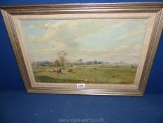 An Oil painting of cows in a meadow, indistinctly signed.