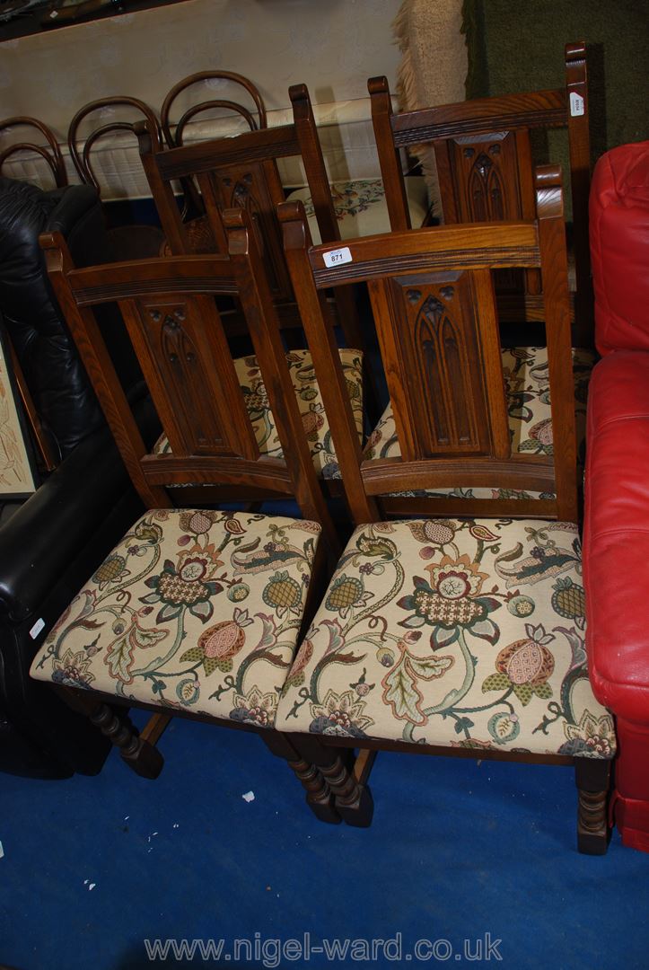 Four upholstered oak dining chairs with barley twist legs.