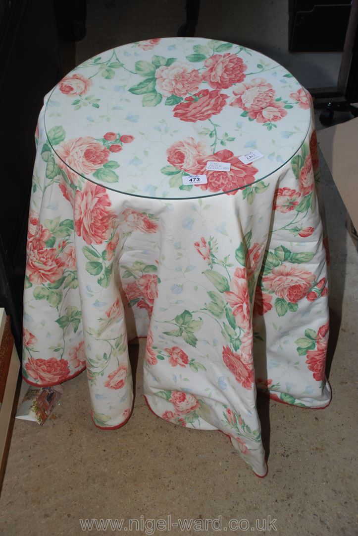 Chipboard occasional table with floral cover and glass top