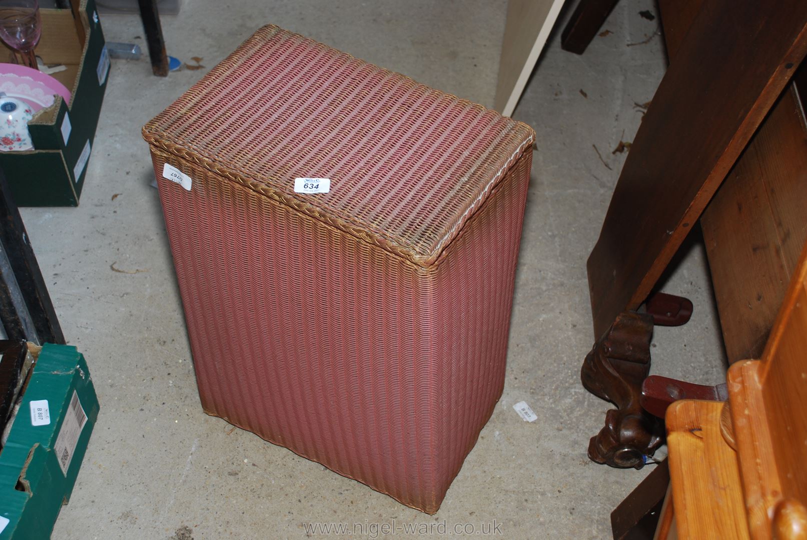 A rectangular Lloyd Loom laundry basket