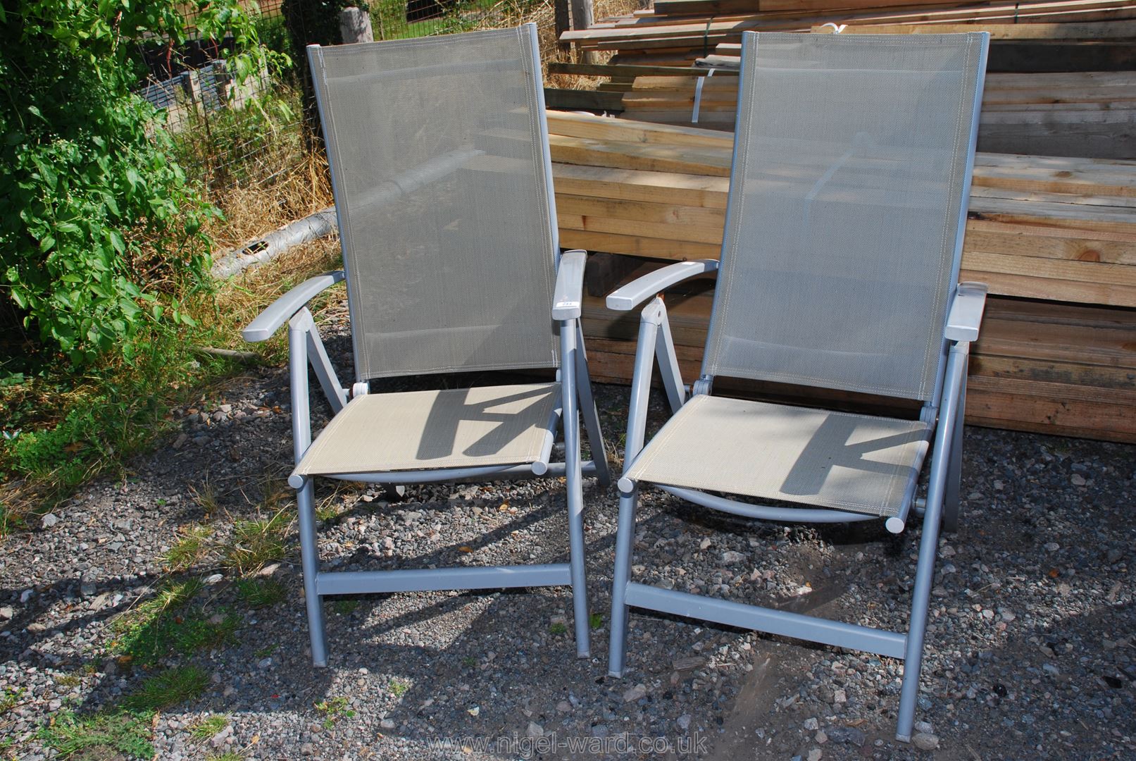 Pair of folding nylon seated deck chairs, (one arm a/f).