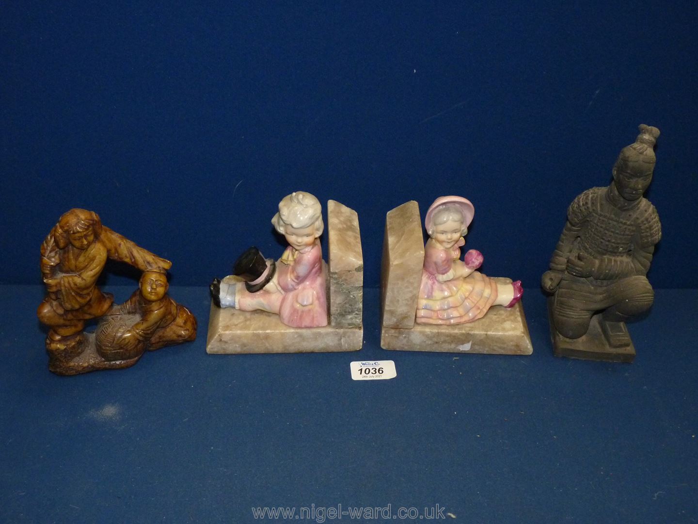 A pair of Marble Bookends, a/f with china figures of seated boy and girl,