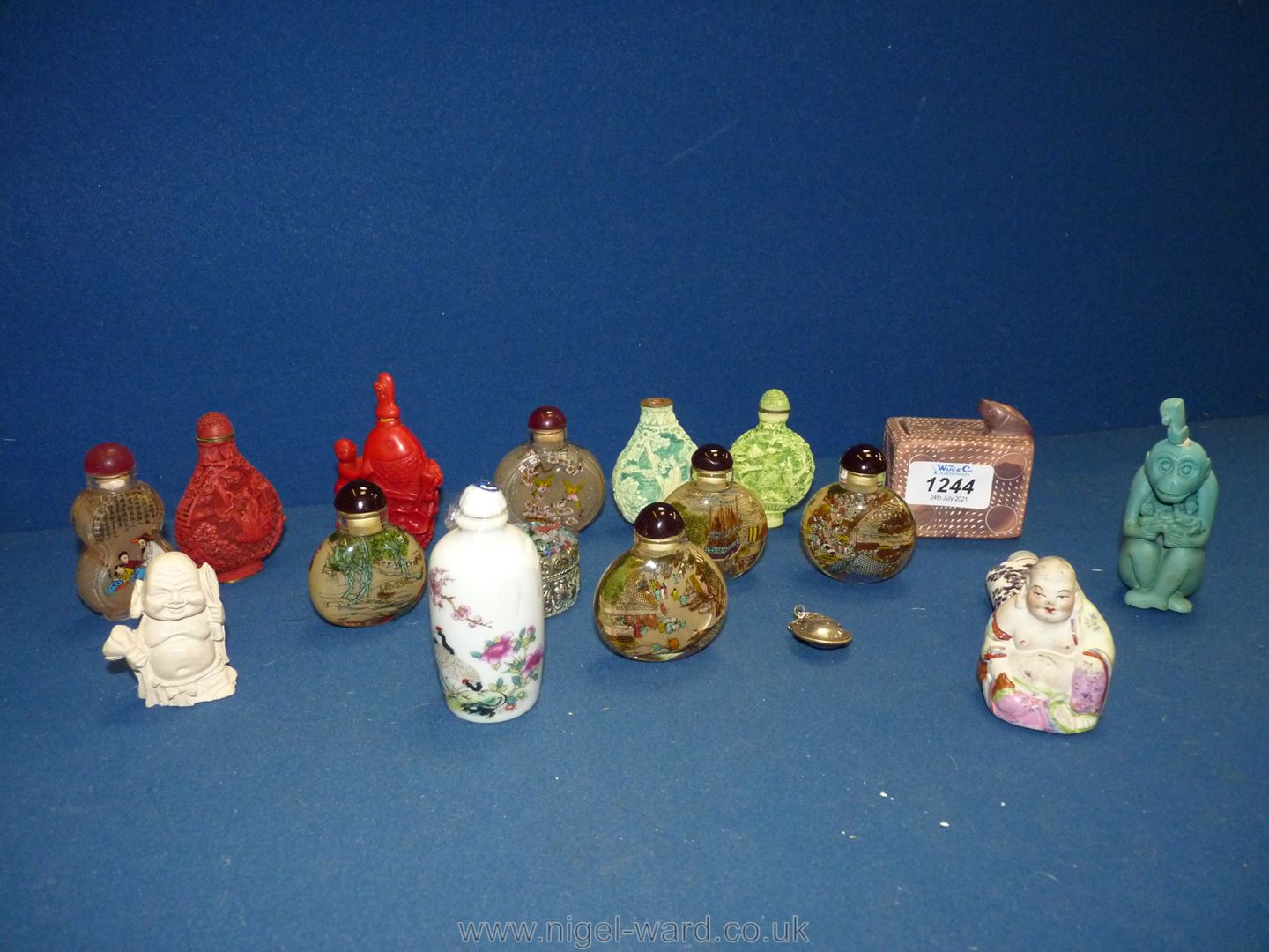 A quantity of oriental snuff/perfume bottles including glass, ceramic, carved cinnabar,