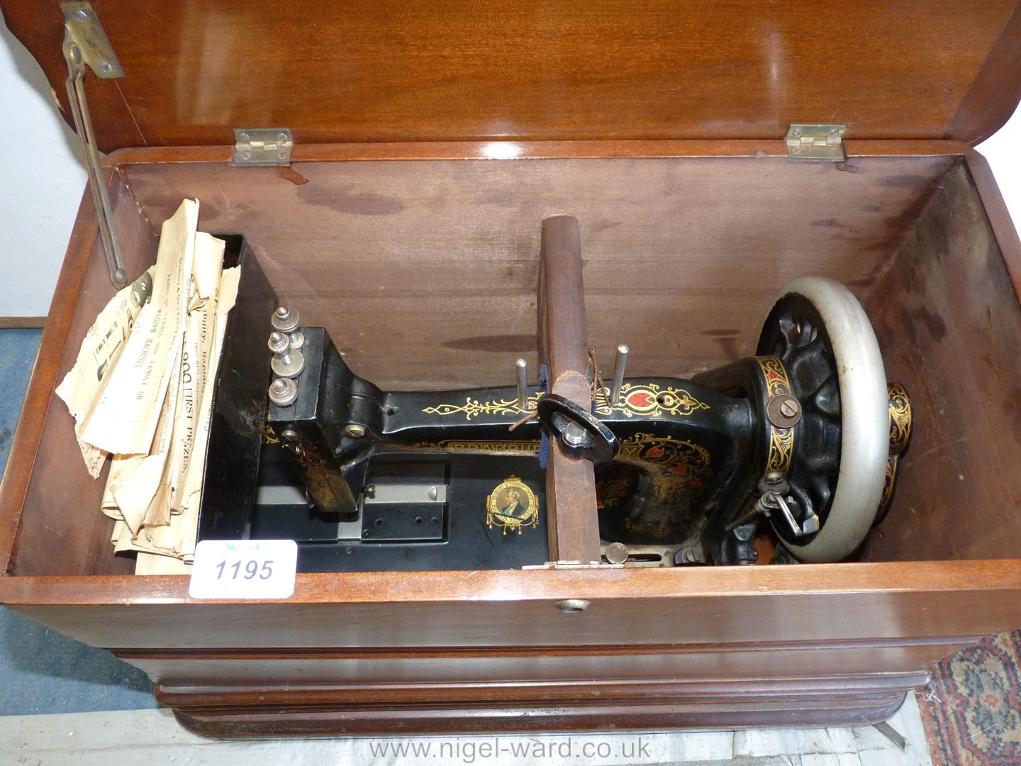 A Bradbury Hand Sewing Machine in wooden case.