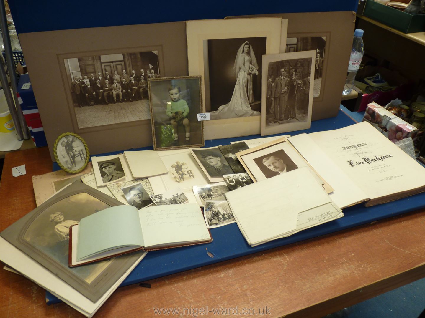 A quantity of black and white photographs and an autograph book.