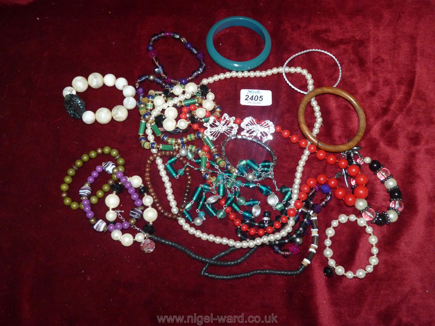 A quantity of costume jewellery to include; beaded bangles, necklaces, butterfly brooches, etc.