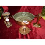 A copper pan, chamberstick, etc.