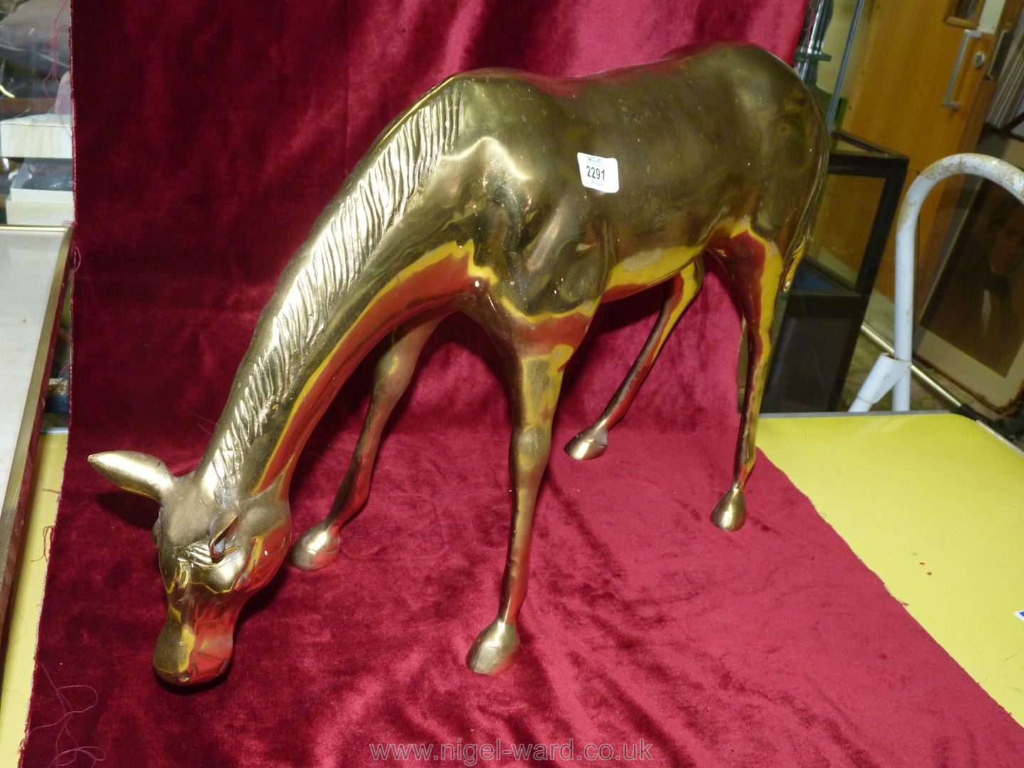 A large brass figure of a horse, 30'' wide x 17'' tall.