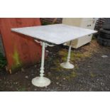 Marbled top table on two metal legs,