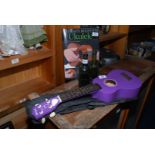 Two collectable beer bottles for Ebbw Vale and Llanfoist, a purple Ukulele and book.
