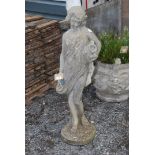 Concrete statue of semi clad female water carrier,