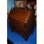 Small Mahogany writing bureau with fitted interior, with three drawers.