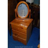 Bedside chest of three drawers and pine swing vanity mirror.