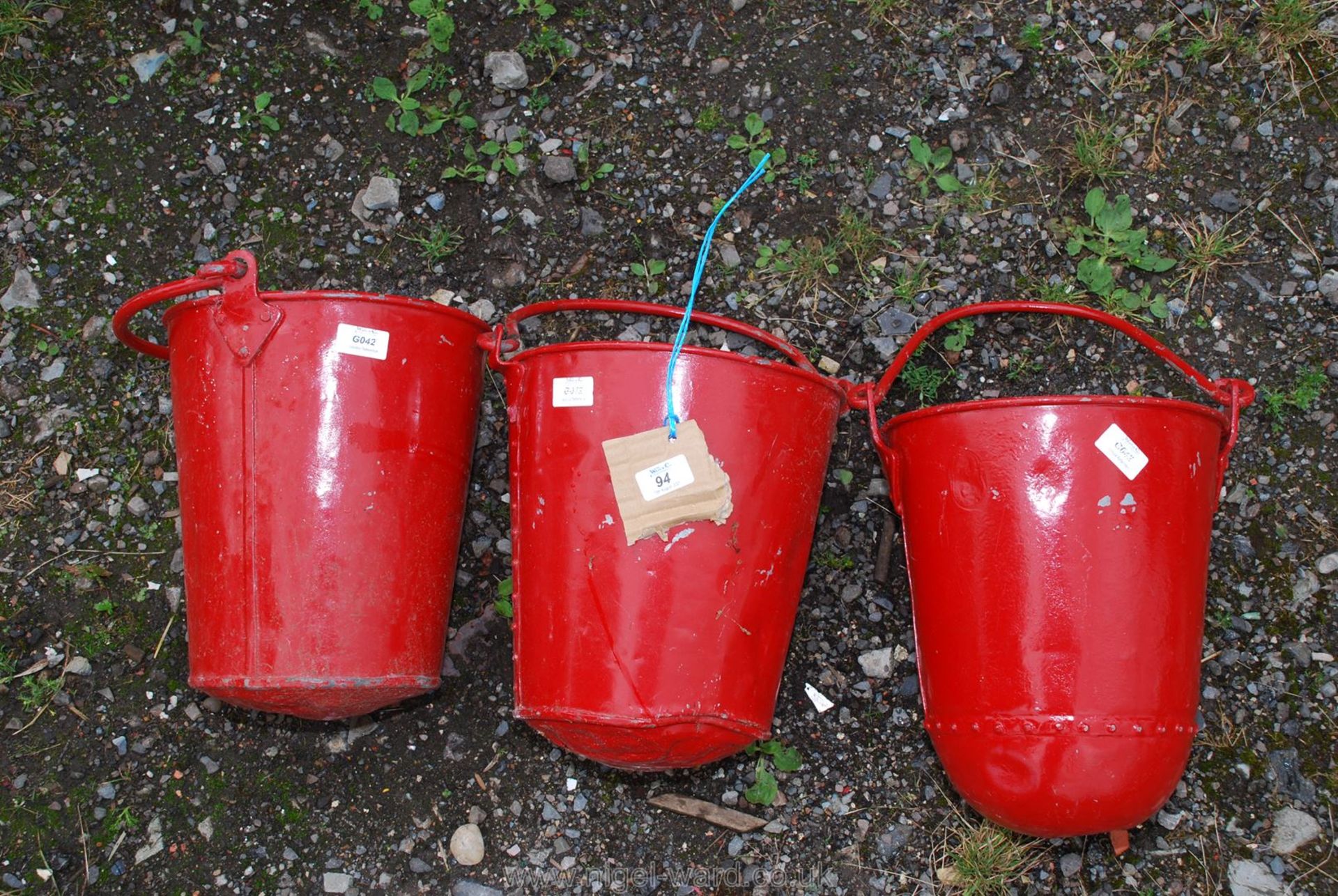 Three galvanised red painted fire buckets,