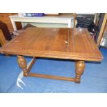 Extending oak draw leaf dining table on square base with four baluster supports,