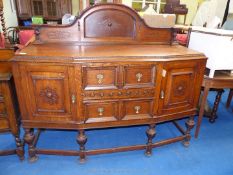 Arts and Crafts style sideboard with two drawers over two cupboards.