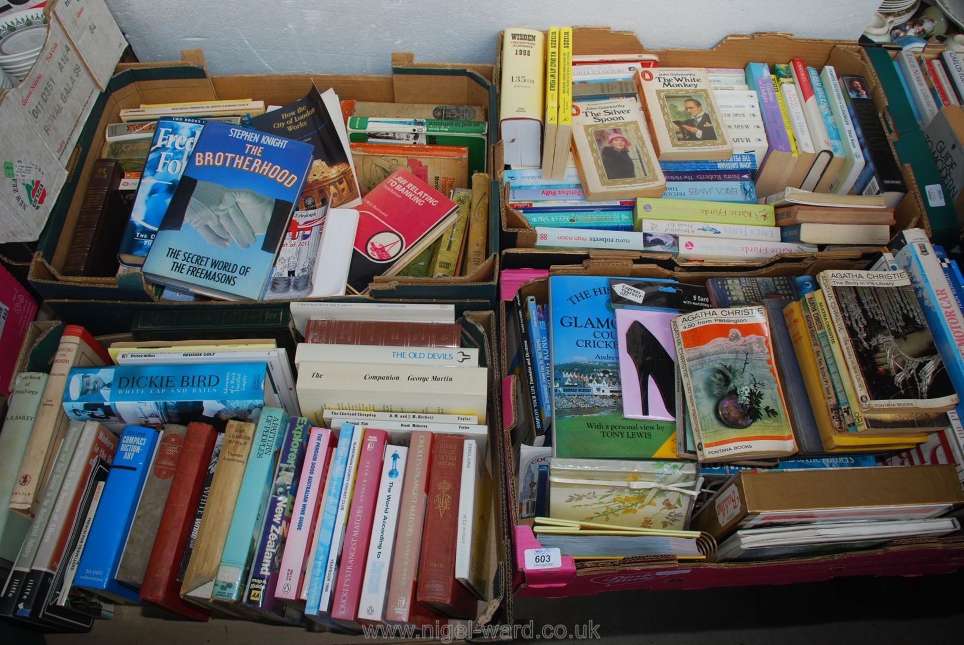 Four boxes of books including; cricket novels, thrillers, etc.