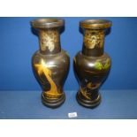 A pair of oriental vases (black and gold) of fishing scene, some splits in wood, 15 1/2" tall.