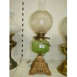 An oil lamp converted to electric with metal base, light green reservoir,