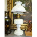 A 1930's oil lamp with white base, chip to shade, 22" tall.