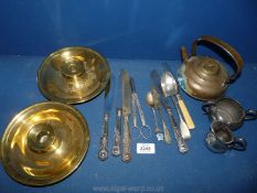 A quantity of metalware to include cutlery, spoons, plated jugs, knives, brass candleholders,