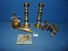A small quantity of brass to include; a pair of candlesticks, small swordfish, brass cannon, etc.