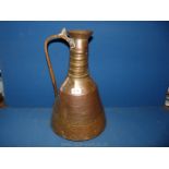 A large Copper water Vessel with handle, hammered decoration to the base, 15 1/2'' tall.