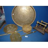 A quantity of brass including chestnut roaster, skimmer, fire iron rests, plaque and charger.