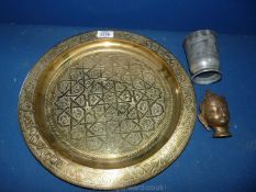 A brass Charger with Islamic style detail, brass Buddha head and half pint Pewter beaker.