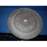 A large metal Charger with Islamic style decoration, 23" diameter.