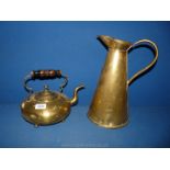 A large conical brass Water Jug and a brass Kettle with turned wood handle,