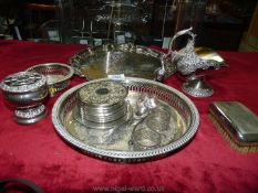 A circular silver plated galleried tray, eight coasters, helmet sugar holder, silver teaspoon, etc.