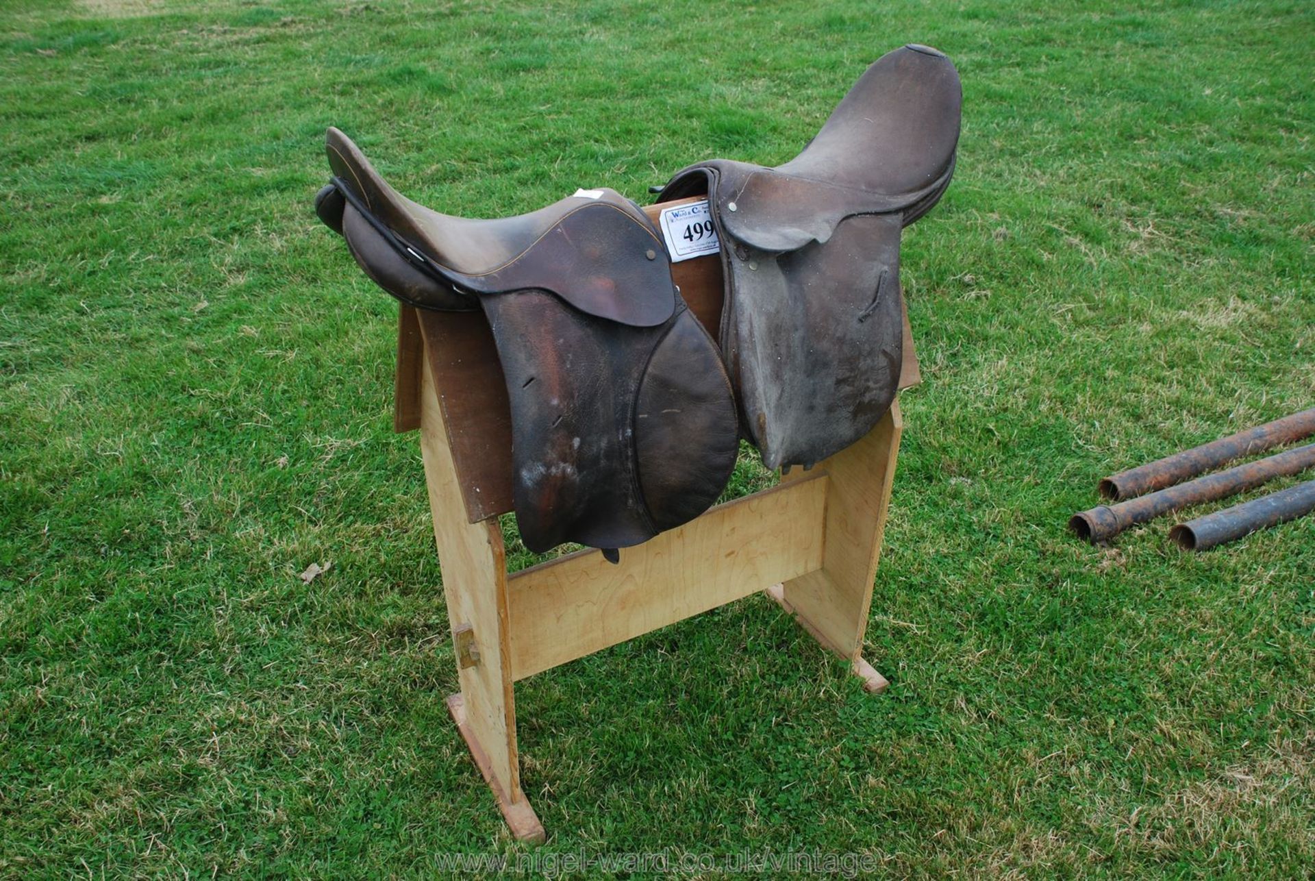 Two brown leather general purpose Saddles, believed English, 16'' approx. on a wooden horse.